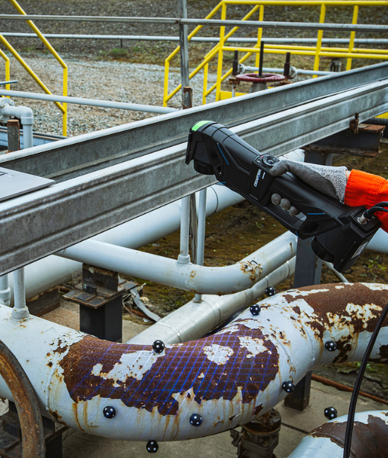 Person using a Creaform HandySCAN MAX to scan a pipeline elbow